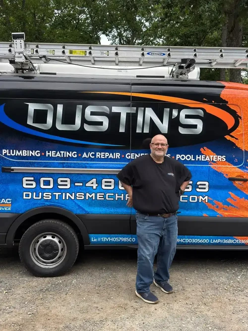 Dustin's Mechanical technician standing in front of truck