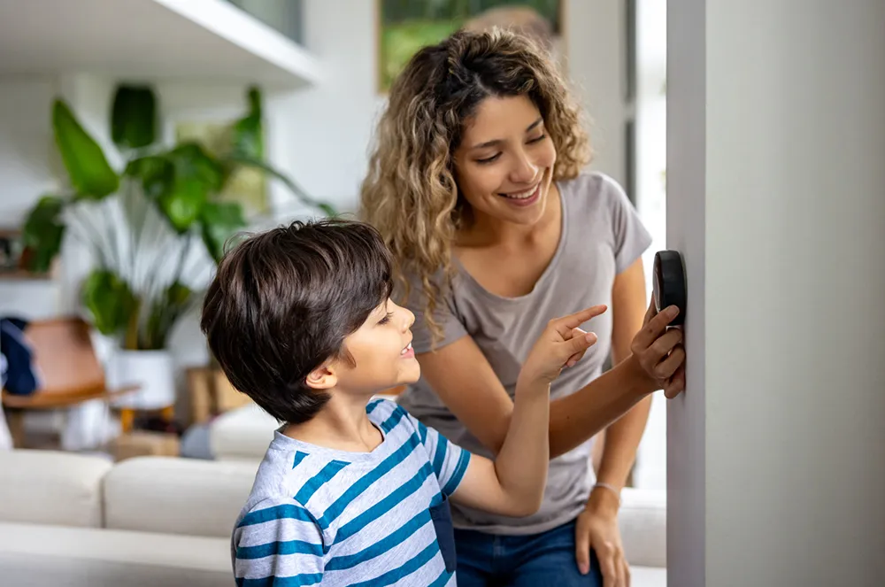 woman showing child how to adjust thermostat in New Egypt, NJ