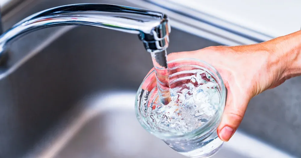water pouring into glass from faucet in new egypt, nj