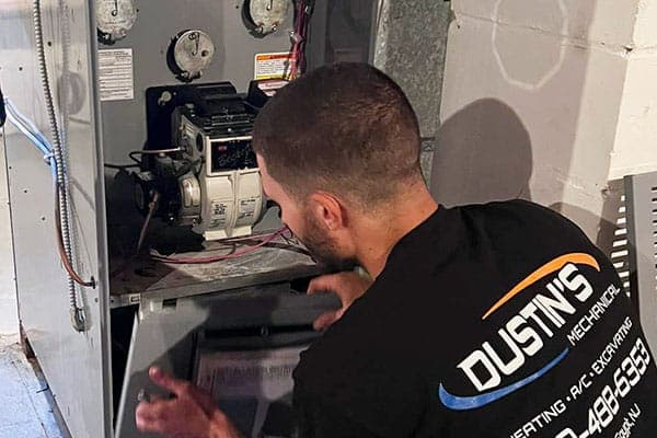 Dustin's Mechanical technician servicing a furnace