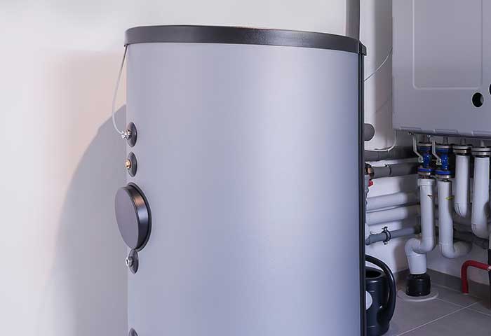 Modern hot water storage tank installed in a utility room
