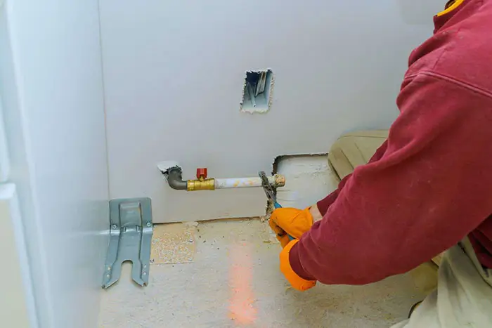Technician installing or repairing a gas line connection
