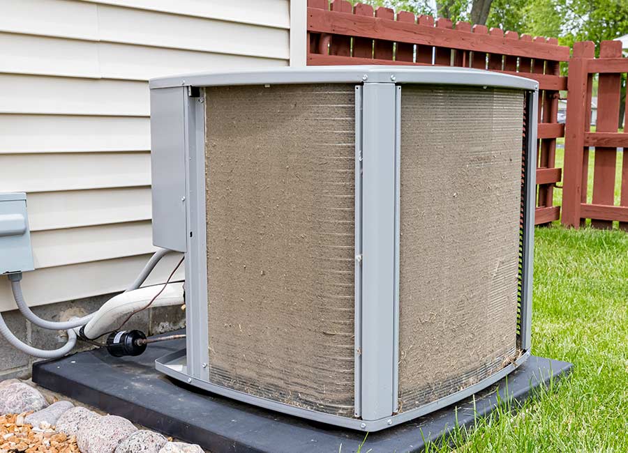 An outdoor AC unit installed on a concrete pad