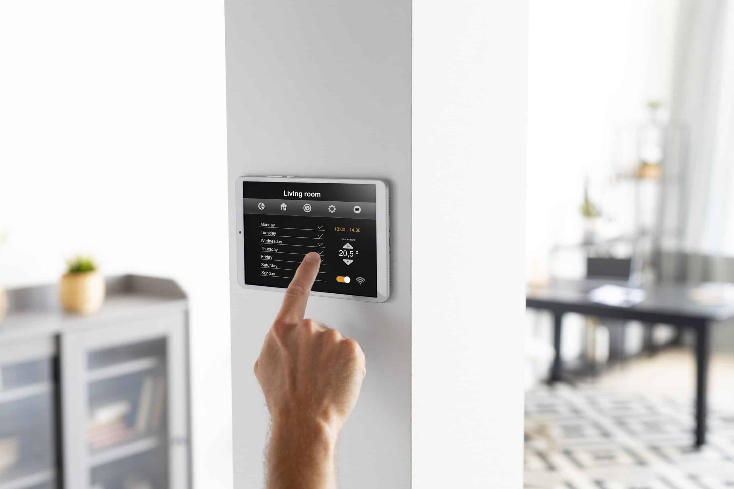 man configuring his ac thermostat